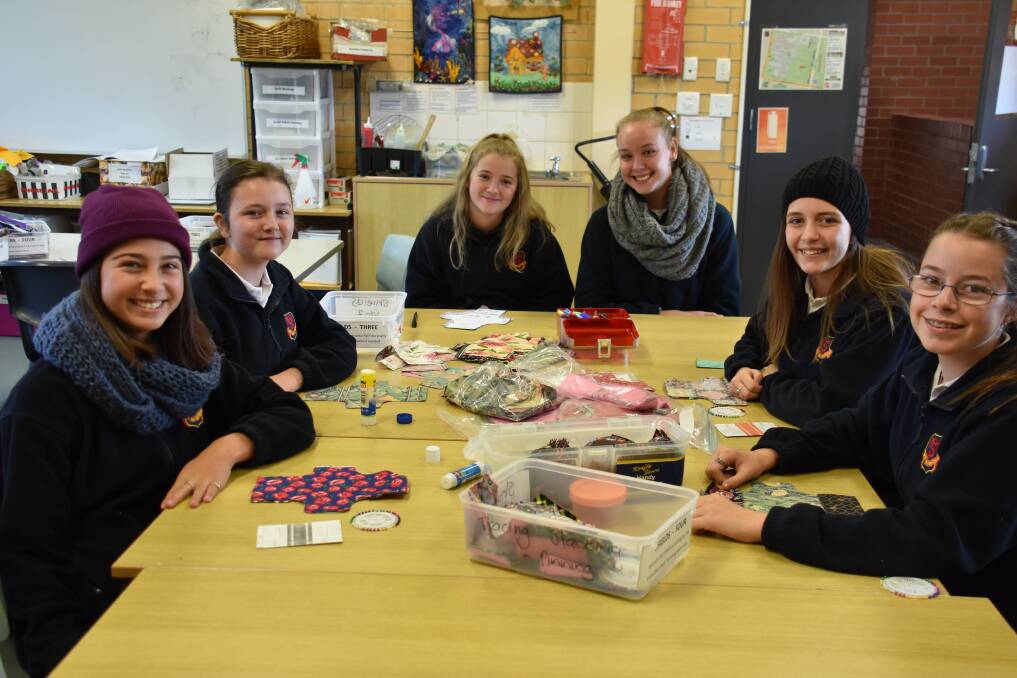 SEW FOR PADS: Mylee Brook, Isobel Denford, Ruby Dyke, Emily Gatley, Wenonah Illy and Rachel Lynn sewing kits for Days for Girls. Photo: Jay-Anna Mobbs