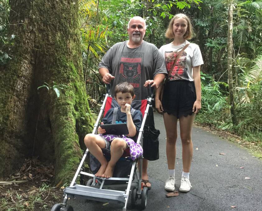 LIFE SAVING SURGERY: Charlie Wheaton, pictured with his children Chaz and Zari Wheaton, urgently needs a surgery to rid of his brain tumour. Photo: Supplied