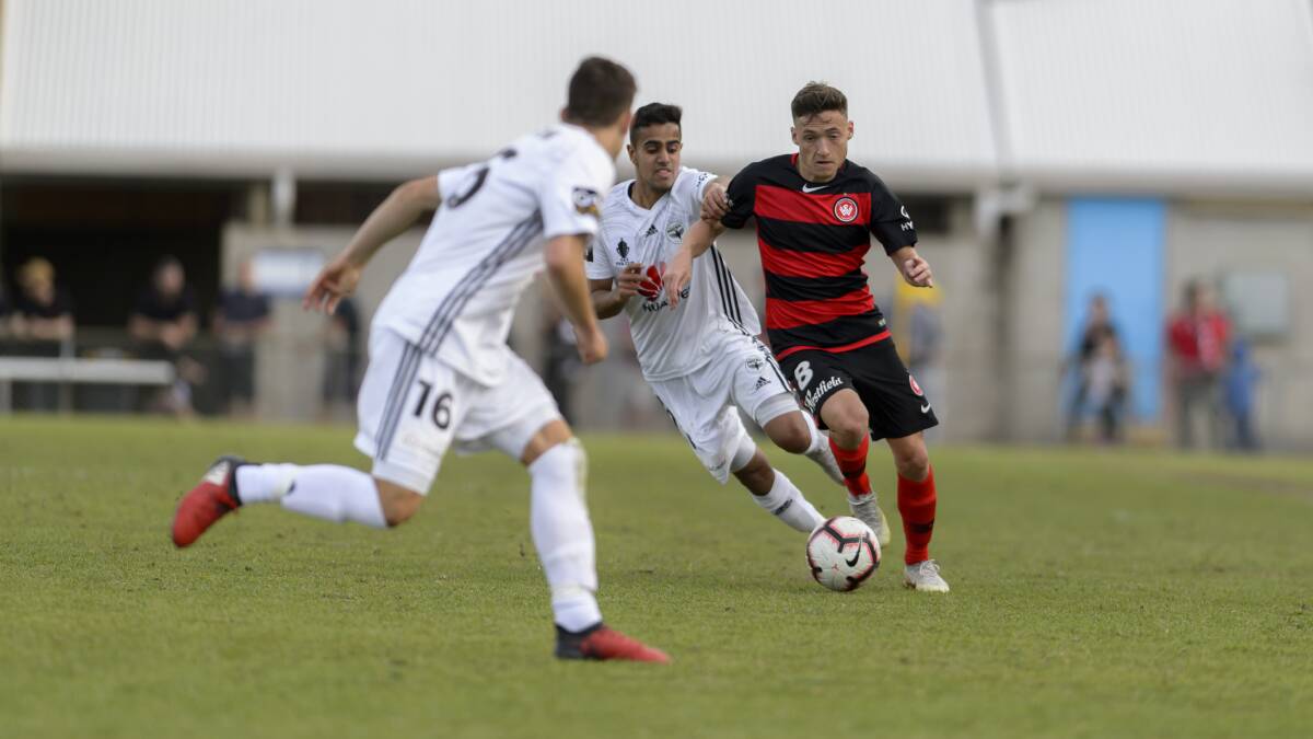 WANDERERS: Jordan O'Doherty (right), pictured making a play against two Wellington Phoenix players, admits he is excited by the prospect of playing in Mudgee. Photo: Supplied