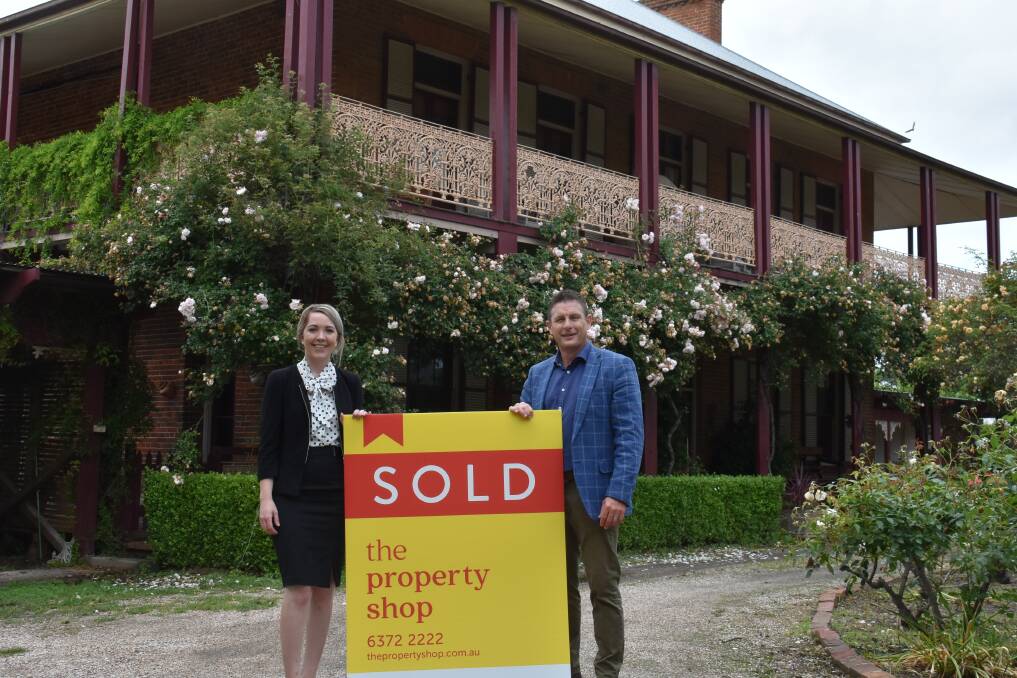 SOLD: Alyse Pilley and Andrew Palmer with a 'SOLD' sign in front of 'Bleak House'. Picture: JAY-ANNA MOBBS