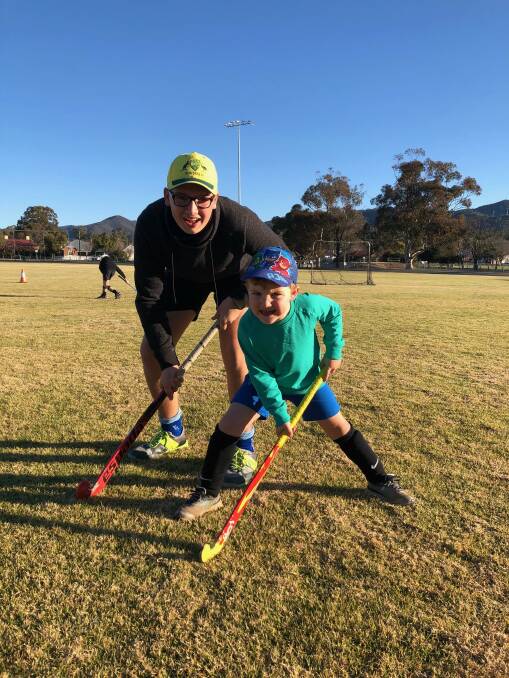 FAMILY FUN: Nic and Henry Myers are both big fans of hockey and look forward to playing each year. Photo: Supplied