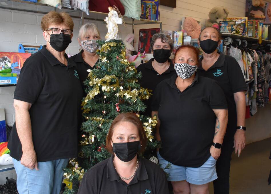 SUPPORTING LOCALS: We Care Community Shop staff instore gathered around their Christmas tree. Picture: JAY-ANNA MOBBS