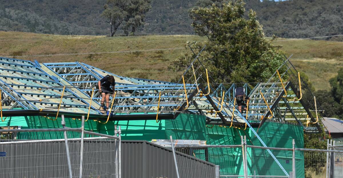 BUILD: A pair of contractors working on the site of a new home in Mudgee. Picture: JAY-ANNA MOBBS