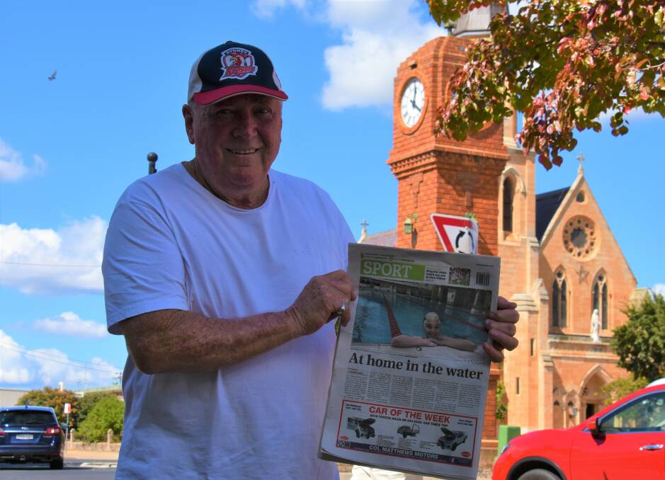 COACH: Mick O'Sullivan proud as punch holding a Mudgee Guardian edition featuring one of his athletes, Edie Keightley. Picture: JAY-ANNA MOBBS
