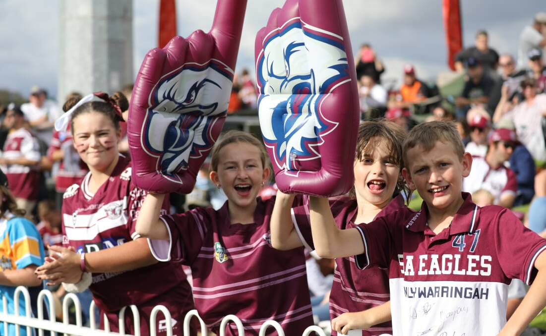 EAGLE ROCK: Four Manly Warringah Sea Eagles fans cheering their team on at Glen Willow earlier this year. Picture: SIMONE KURTZ