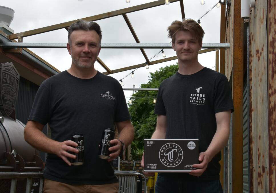BREW: Three Tails head brewer Scott O'Brien holding with Thomas Swords in front of the smoker, 'The Governor'. Picture: JAY-ANNA MOBBS