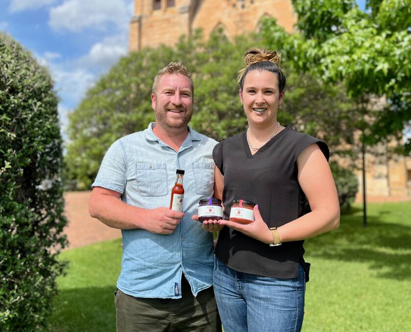 WHERE IT ALL BEGAN: Marc Everson and Kate Cunningham in front of St Mary's Catholic Church where they sold their first roll under Marc's BBQ. Picture: BENJAMIN PALMER