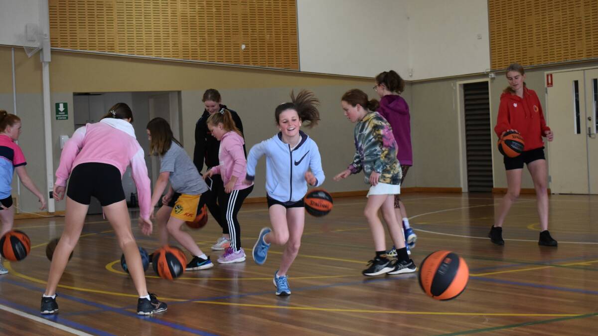 LEARNING: Throughout the 'come and try' session, the girls were taught various skills and drills. Photo: Supplied