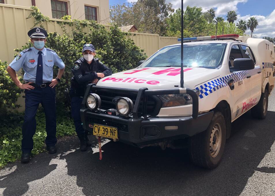 READY FOR THE ROAD: Inspector Mark Fehon and Senior Constable Marie Godzik with Mudgee Police Station's pinked up police car. Photo: Supplied