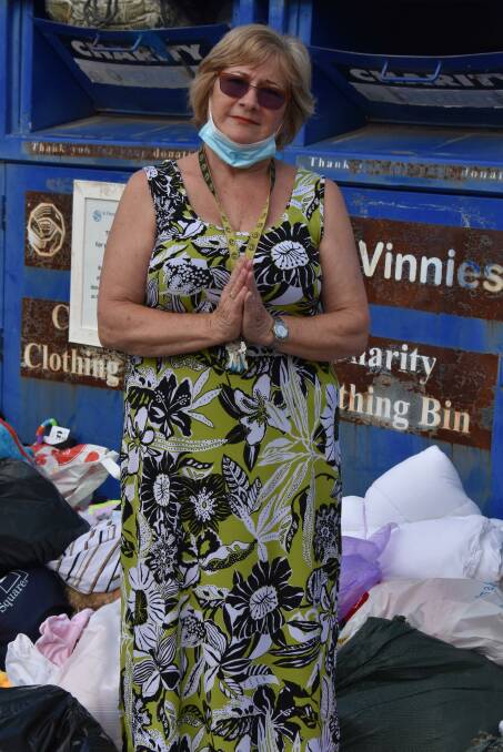 PRAY: Mudgee St Vincent de Paul Society president, Carol Jones standing infront of the dumped donations praying it doesn't happen again. Picture: JAY-ANNA MOBBS 