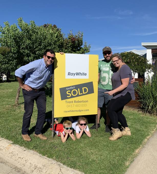 HOT TIPS: Ray White Mudgee director, Trent Robertson with clients who recently bought a new home. Picture: RAY WHITE MUDGEE