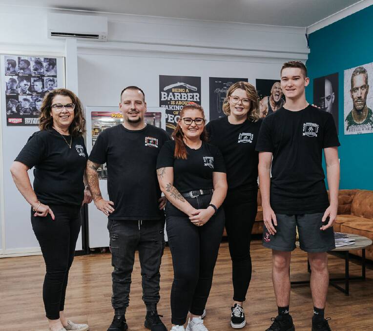TEAM WORK: Not only do the staff at Ronnie's Barber Shop 'think the world' of their boss Ronnie Denniss (second from left), but so does the local community. Photo: Social Focus 