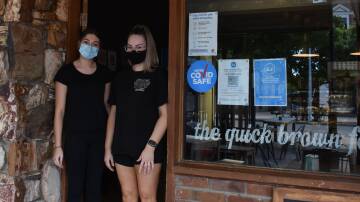 Hannah Clark and Lacey Bennett at the entrance to The Quick Brown Fox in December 2021 where Dine vouchers are accepted. Picture: Jay-Anna Mobbs