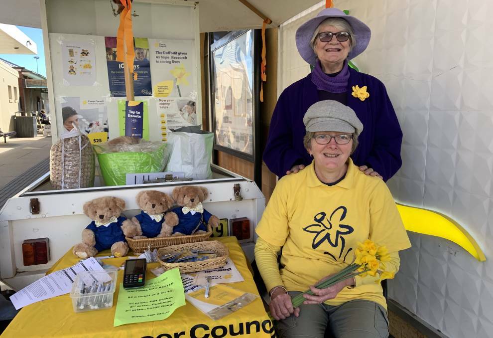 SUPPORT: Alison Hughes (seated) and Marie Denniss at the Mudgee Daffodil Day stall in its usual spot near St George bank on Church Street in 2019.