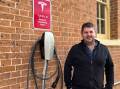 Mid-Western Regional councillor Paul Cavalier next to a Tesla destination charging station in Mudgee. Picture: Benjamin Palmer
