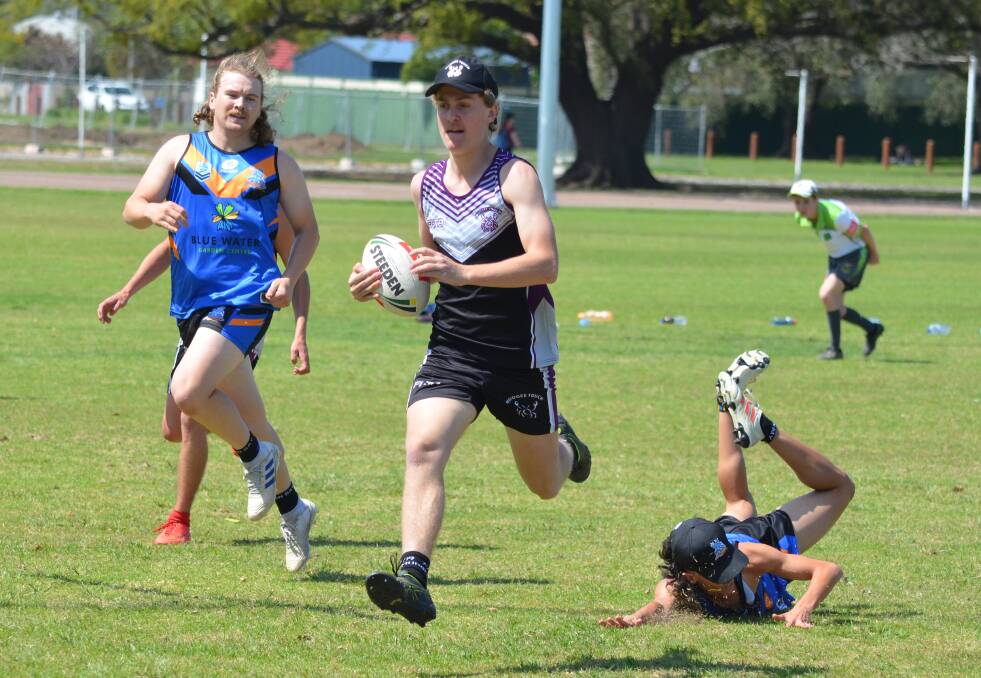 OUT OF REACH: Mudgee Mudcrabs' Toby Forrest gets away from his Nelson Bay rival at the Hornets Championships last year. Photo: Supplied