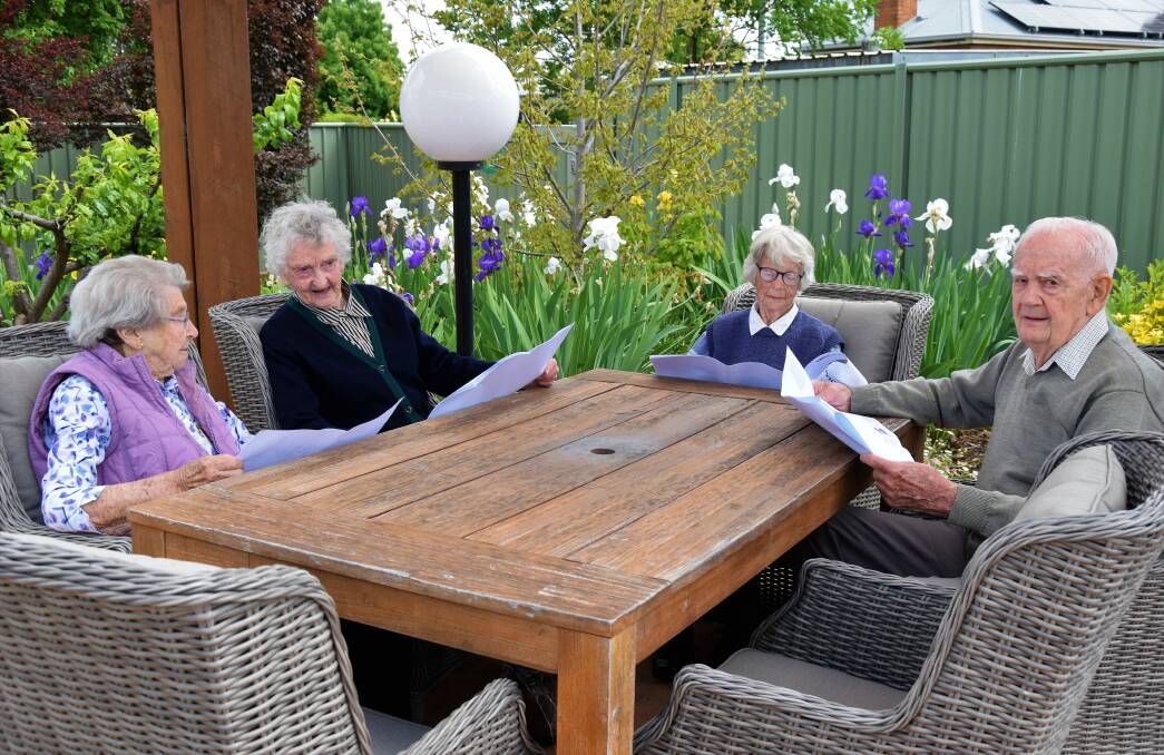 IMPROVEMENTS: Kanandah residents Joyce Sutherland, Dot Robinson, Edna Stanford and Jim Bremmer relaxing in the stunning Kanandah gardens examining the plans for the new hostel wing. Picture: SUPPLIED