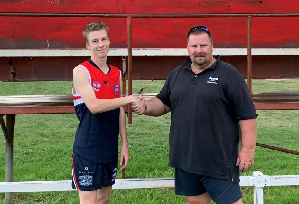 PARTNERSHIP: Lorcan Hayes shaking hands with Dubbo Junior AFL's under 17s coach, Michael Armstrong. Photo: Supplied