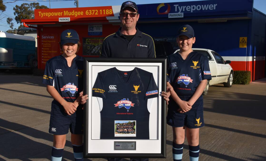 SUPPORT: Rolly Smith and Ollie Gaden presented Matt McPherson (middle) of Tyrepower Mudgee with a framed jersey for the businesses support. Photo: Jay-Anna Mobbs