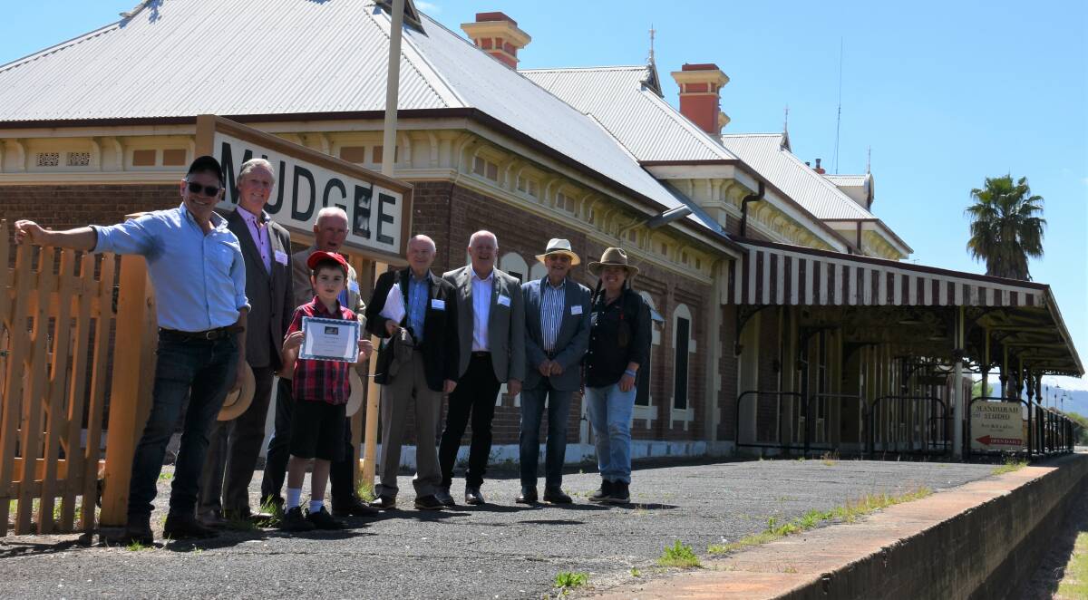 BRING THEM BACK: Six of the seven Mudgee Region Passenger Rail Inc members with locals Adam (front) and Simone Kurtz (right) at the Mudgee platform. Picture: JAY-ANNA MOBBS