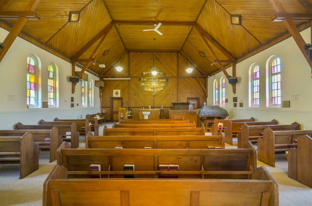 TIMBER AND STAINED GLASS: Inside the church building. Photo: Supplied