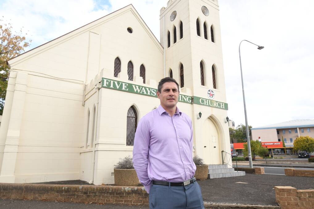 UP FOR SALE: Benchmark real estate director Nigel Staniforth outside the closed Five Ways Uniting Church which is up for auction. Photo: JUDE KEOGH 0328jkfiveways1