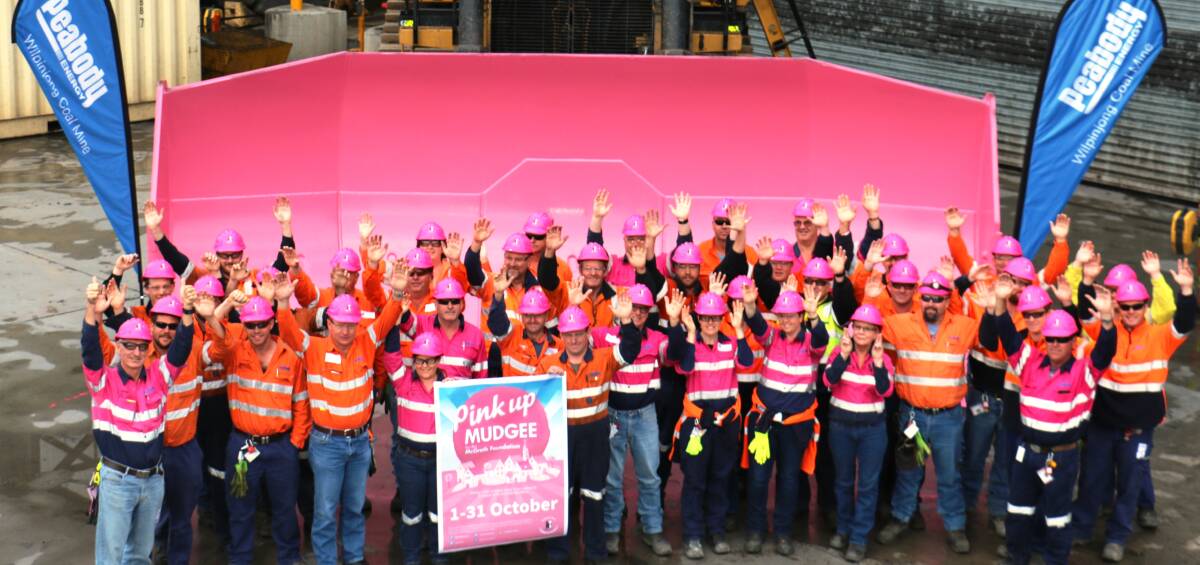 DIG IT:  Peabody Wilpinjong workers pose in pink helmets in front of a pink mine dozer to show their support for "Pink Up Mudgee".  