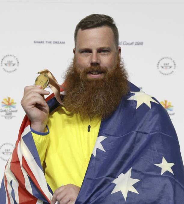 Daniel Repacholi shows his gold medal after victory during the men's 50m Pistol final. Photo: AP/Tertius Pickard