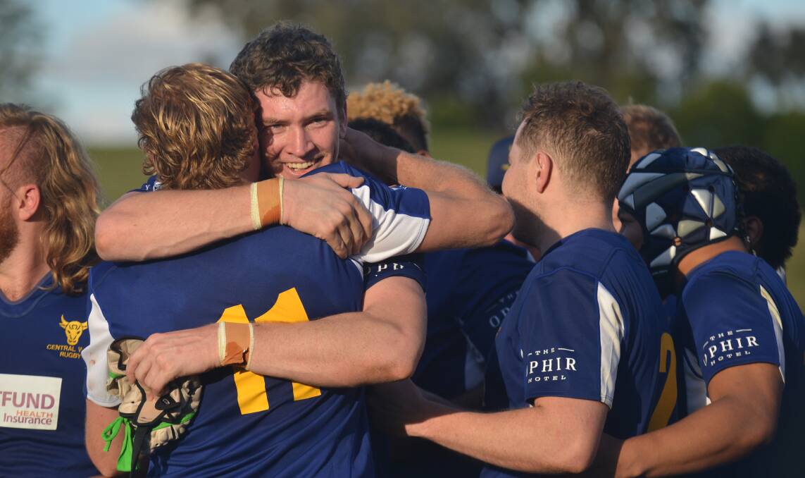 TEAM-MATES AND BROTHERS: Justin Mobbs hugs a fellow Blue Bull after last year's Caldwell Cup triumph. It is that camaraderie which will be a key factor for Central West this weekend. Photo: NORTHERN DAILY LEADER