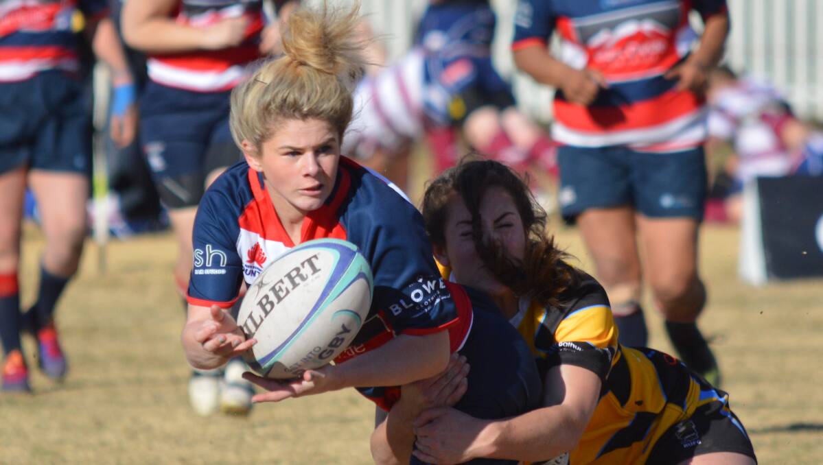 OFFLOAD: Wombats' Brooke Williams looks to promote the footy during the Ferguson Cup finals at Molong. Photo: MATT FINDLAY