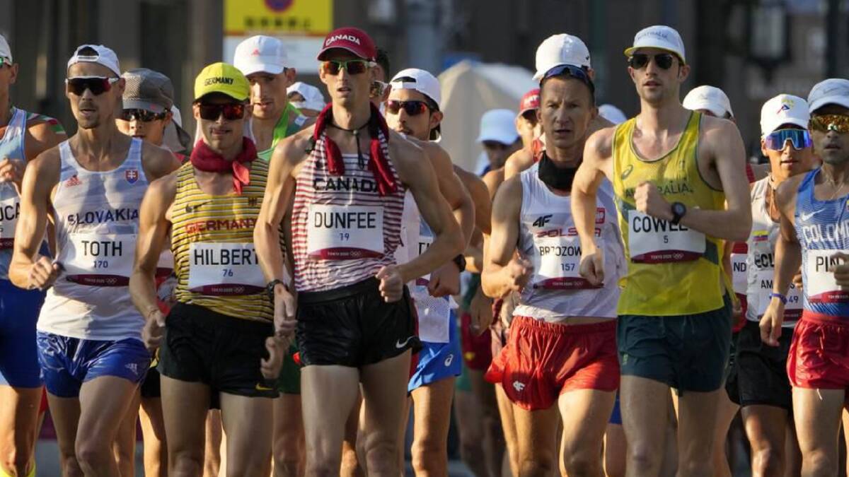Australian Rhydian Cowley (yellow singlet on the right) has finished a creditable eighth in the Olympic 50km walk.