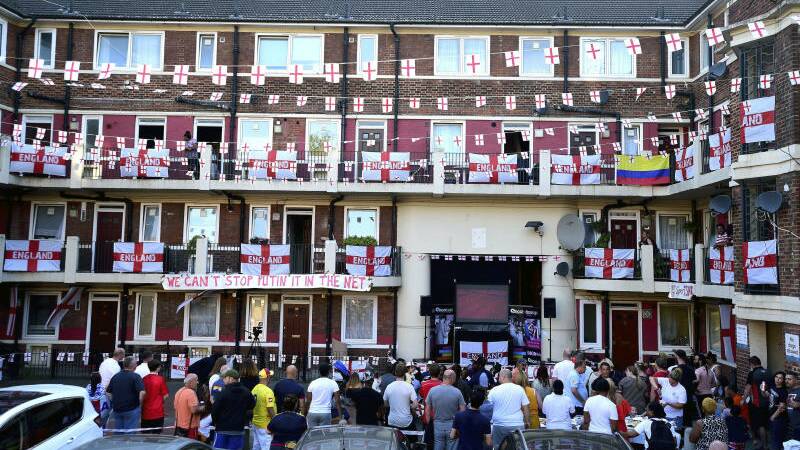 England flags are put up on the Kirby Estate as residents watch the group G soccer match between England and Belgium. Photo: David Mirzoff/PA via AP