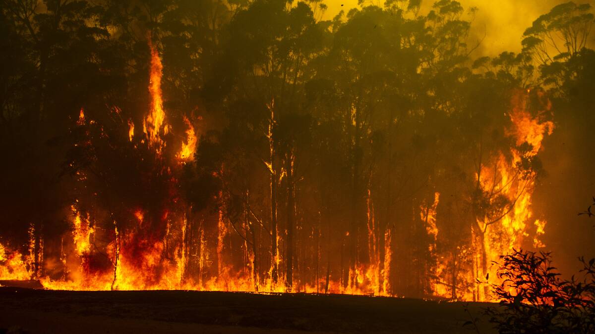Wreck Bay fire crew protect a property from the Currowan fire. Photo: Canberra Times