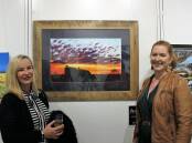 STAND OUT: Bourke artist Merren Turnbull with Mudgee-based judge Lizzy Galloway in front of 'Run for Your Money' which was the winner of the ABC Western Plains prize at Art Unlimited at Dunedoo. Photo: CONTRIBUTED
