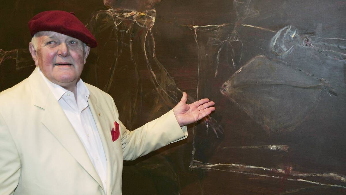 John Olsen poses in front of his work "Self Portrait Janus Faced" after winning the 2005 Archibald prize at the Art Gallery of NSW. Picture Getty Images