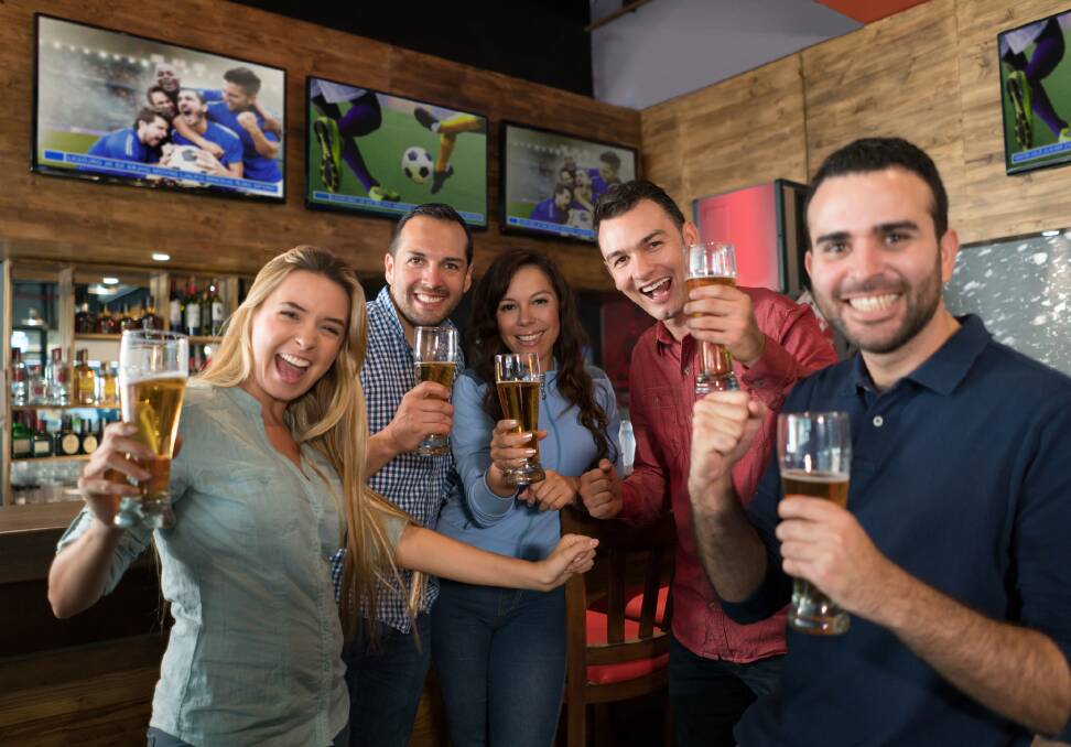 GO TEAM:  As a nation of sports lovers, there’s a great sense of community and camaraderie when the entire population of a pub is watching the big game on the big screen. Photos: iStock - Andresr