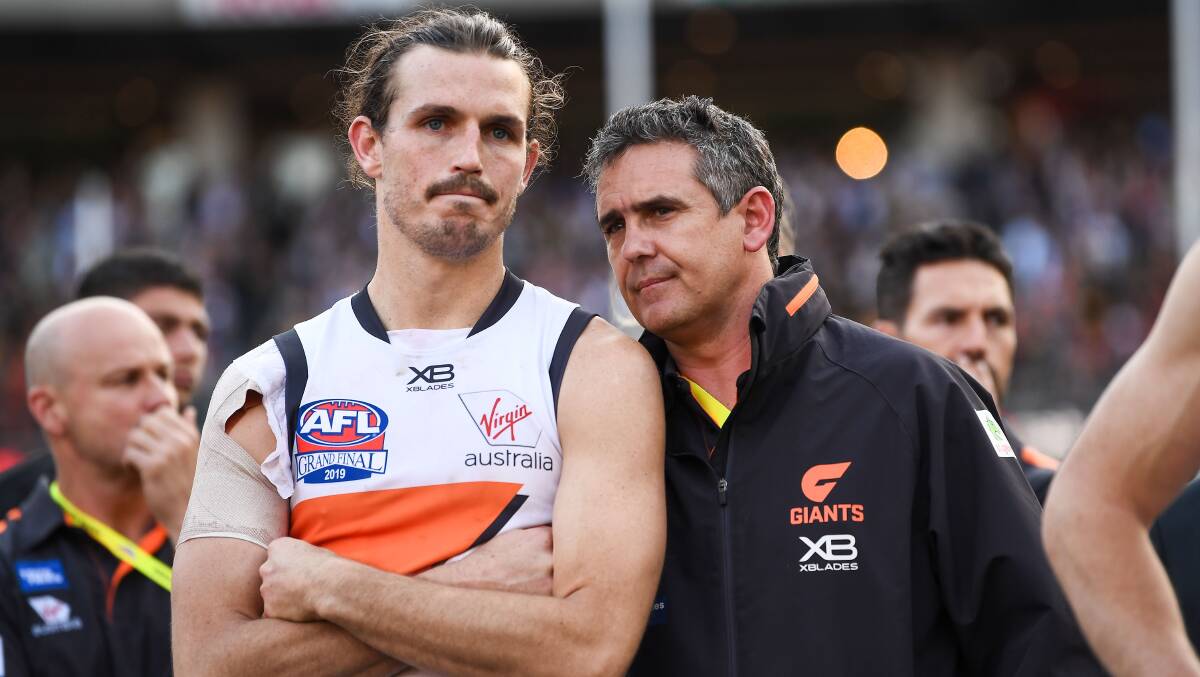 Leon Cameron with Phil Davis after the 2019 AFL grand final. Not a champion this day, but an undisputed champion, regardless. Picture: Getty Images