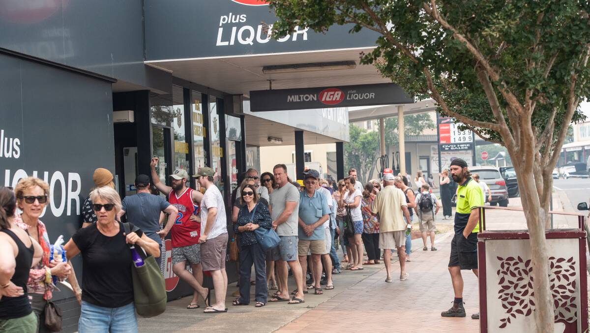 Long queues form at a supermarket in Milton. Authorities want holidaymakers to leave the South Coast before Saturday. Picture: Karleen Minney