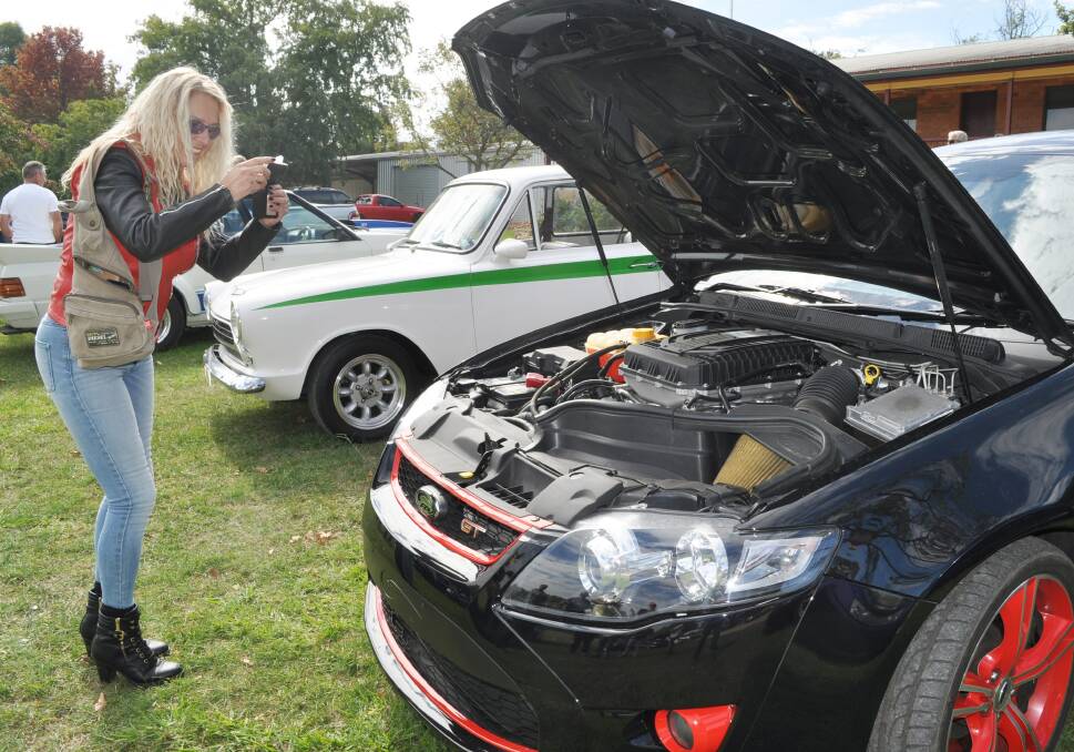 SNAP: Cilla Freeman from Picton photographing a GT Falcon at the Rystone Markets.