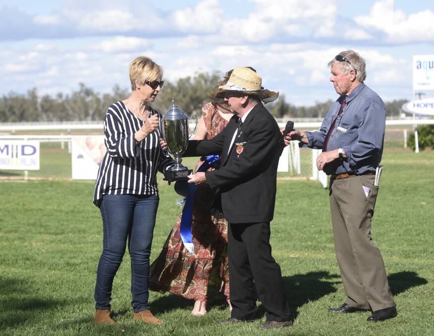 Gayna Williams receives the Royal Hotel Iris Rennie Memorial Manilla Cup from Royal Hotel licensee Tom Cocking.