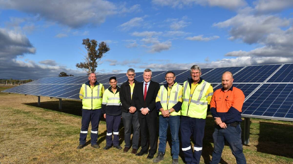 Mid-Western Regional Council general manager Brad Cam (centre) inspecting the solar panels with council workers.