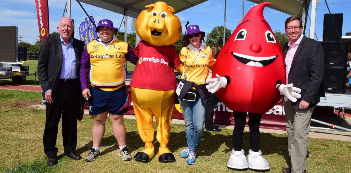 Advocating: Cancer Council NSW's Katherine Hodges (between mascots) at the Orana Relay for Life, where the push for palliative care continued.
