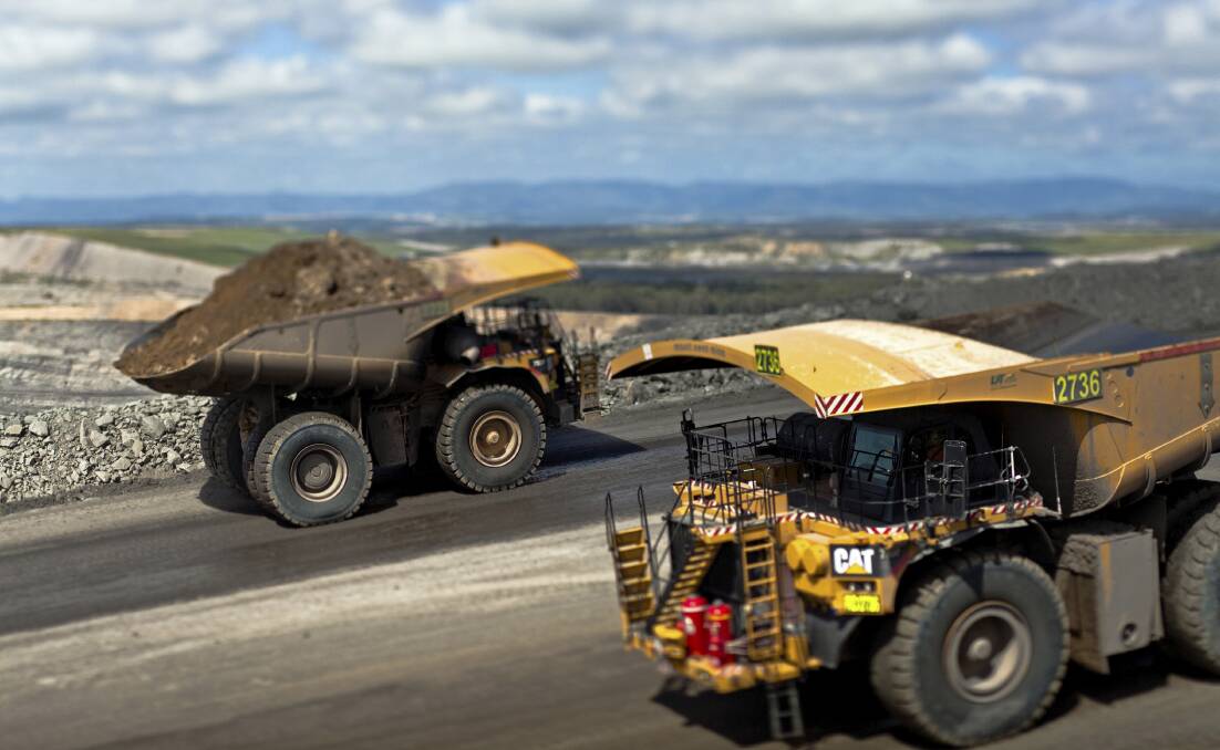 History: Trucks at Glencore's Mount Owen mine. A company email to the Independent Planning Commission has raised new questions about transparency in the state's mine assessment processes. 