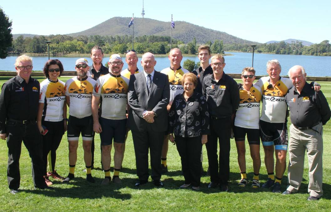 HONOURED: Stuart Clifford (back row, second from right), Andrew (far left) and Ritchie (far right) McKay and Zoo2Zoo riders with Their Excellencies, The Governor-General Sir Peter Cosgrove and Lady Lynne Cosgrove. Photo: FIONA HARTLEY