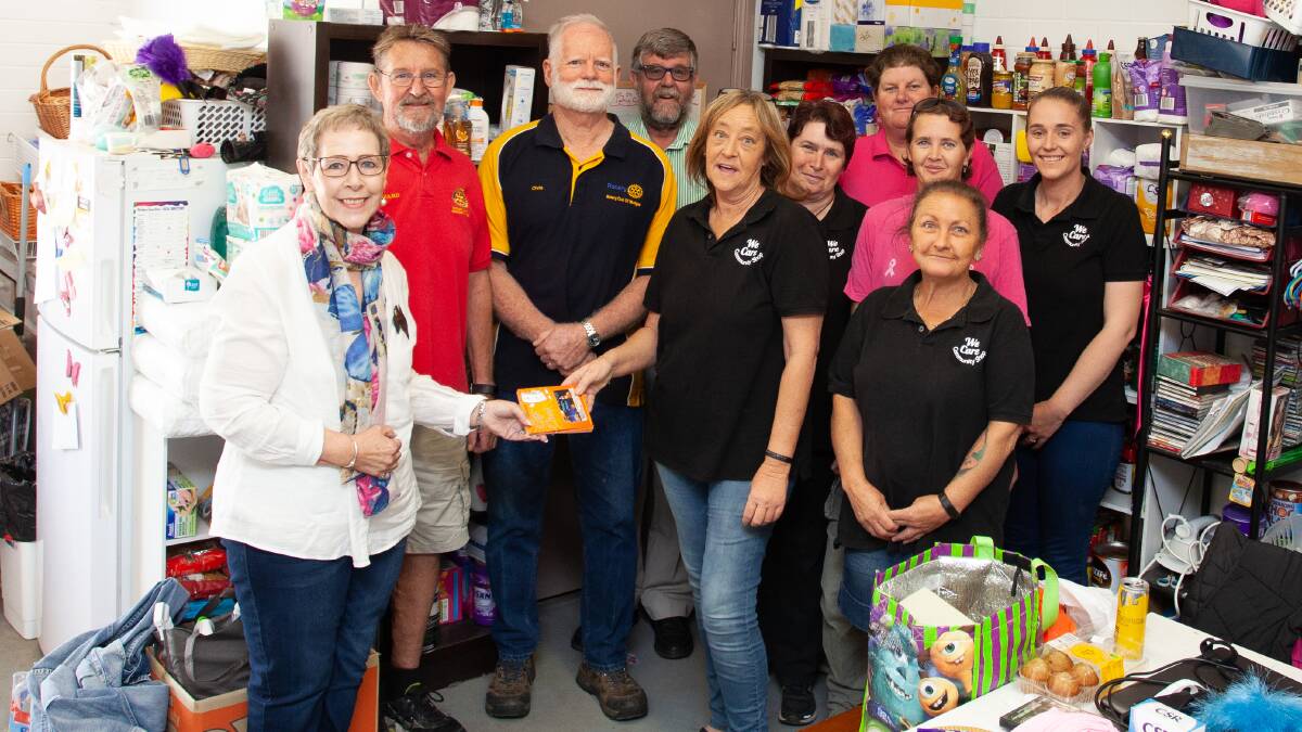 Local Rotary representatives pass on Mudgee Money cards for distribution to recipients in the MWRC area.