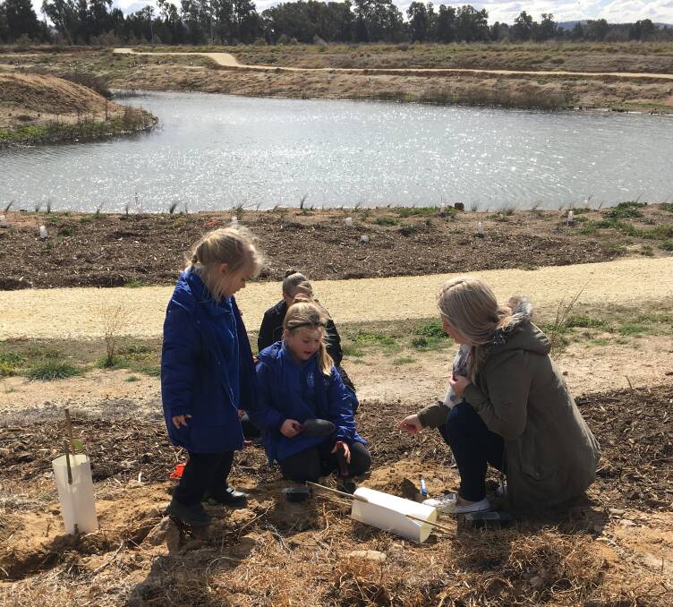 Ellie and Charli Statham with mum Kara help with regeneration of Putta Bucca Wetlands area as part of National Tree Day events.