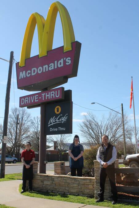 McDonald's Mudgee licensee Daniel Zammit and staff members Evan and Sheldon, at the soon to be replaced, origingal pylon, that's been in place since the 1990s.