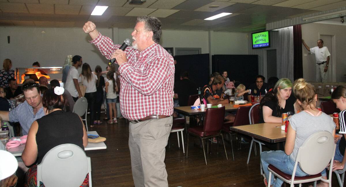 Bruce McGregor auctions off the 50 rabbits to the punters to then race.