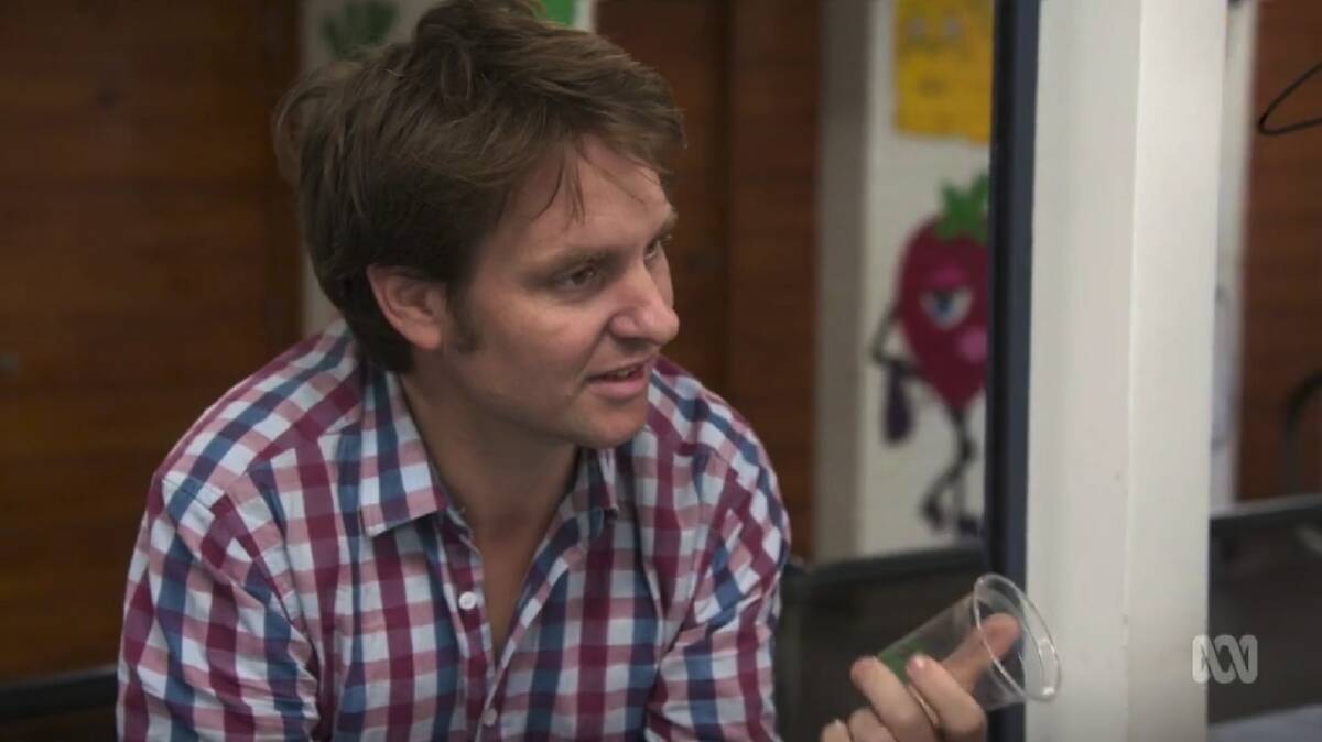 Craig Reucassel with a compostable plant-based bioplastic BioCup at Kiama High School canteen. Image sourced from ABC War On Waste Season 2 episode 3.
