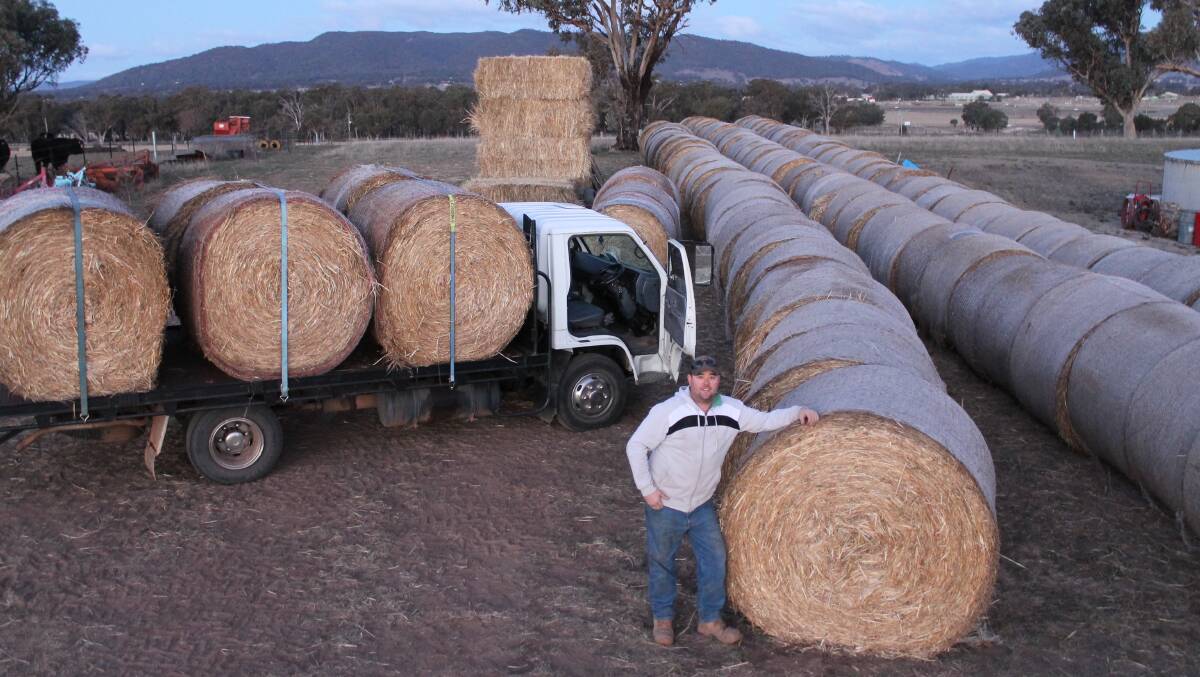 ROLL-OUT: Will Bateman, one of the organisers of 200BALES, with one of the trucks that took hay to local farmers last weekend.